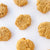 top view of seven light brown peanut butter cookies on a white background