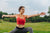 Image of a woman doing a yoga pose in an outdoor set up.