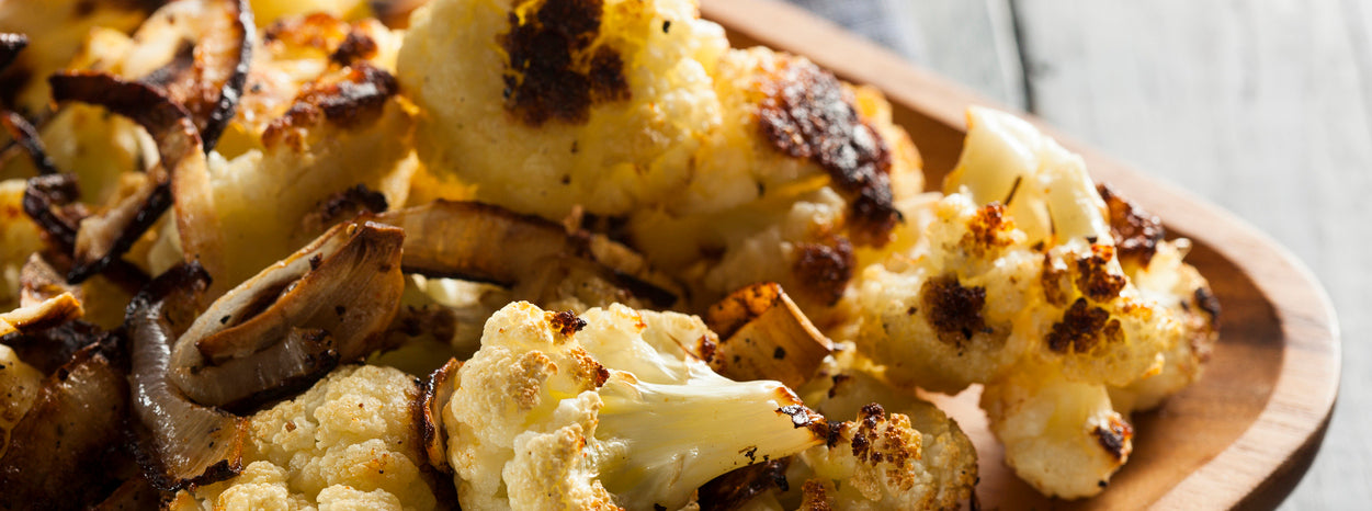 roasted cauliflower in a wooden rectangular plate
