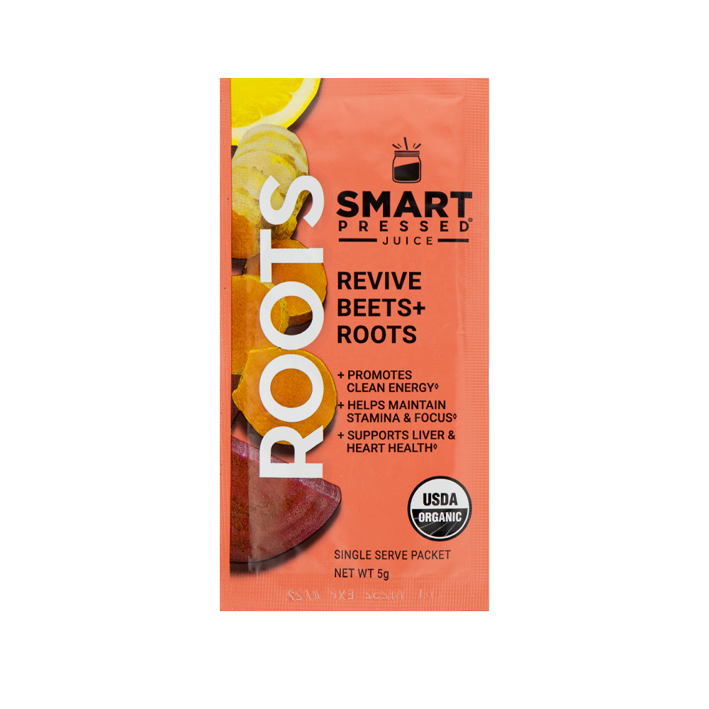 A red colored sachet of Smart Pressed Revive Beets & Roots, which has cover art containing a lemon slice, turmeric slices, and a slice of beets. The text reads Roots, Revive Beets and Roots, promotes clean energy, helps maintain stamina & focus, supports liver & heart health, single serving packet, 8 grams. Contains the USDA certified organic logo