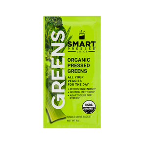 A bright green colored sachet of Smart Pressed Organic Pressed Greens, which has cover art a kale leaf, a celery stalk, and text which reads Greens, Organic Pressed Greens, All your veggies for the day, refreshing energy, neutralize toxins, adaptogens for stress, single serving packet, 8 grams. Contains the USDA certified organic logo