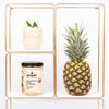 Metallic storage shelves- the first box has a glass of beige drink with a leaf garnish and below it is one jar of pineapple chia cleanse, and on the right side is a pineapple fruit. Set against a white background.