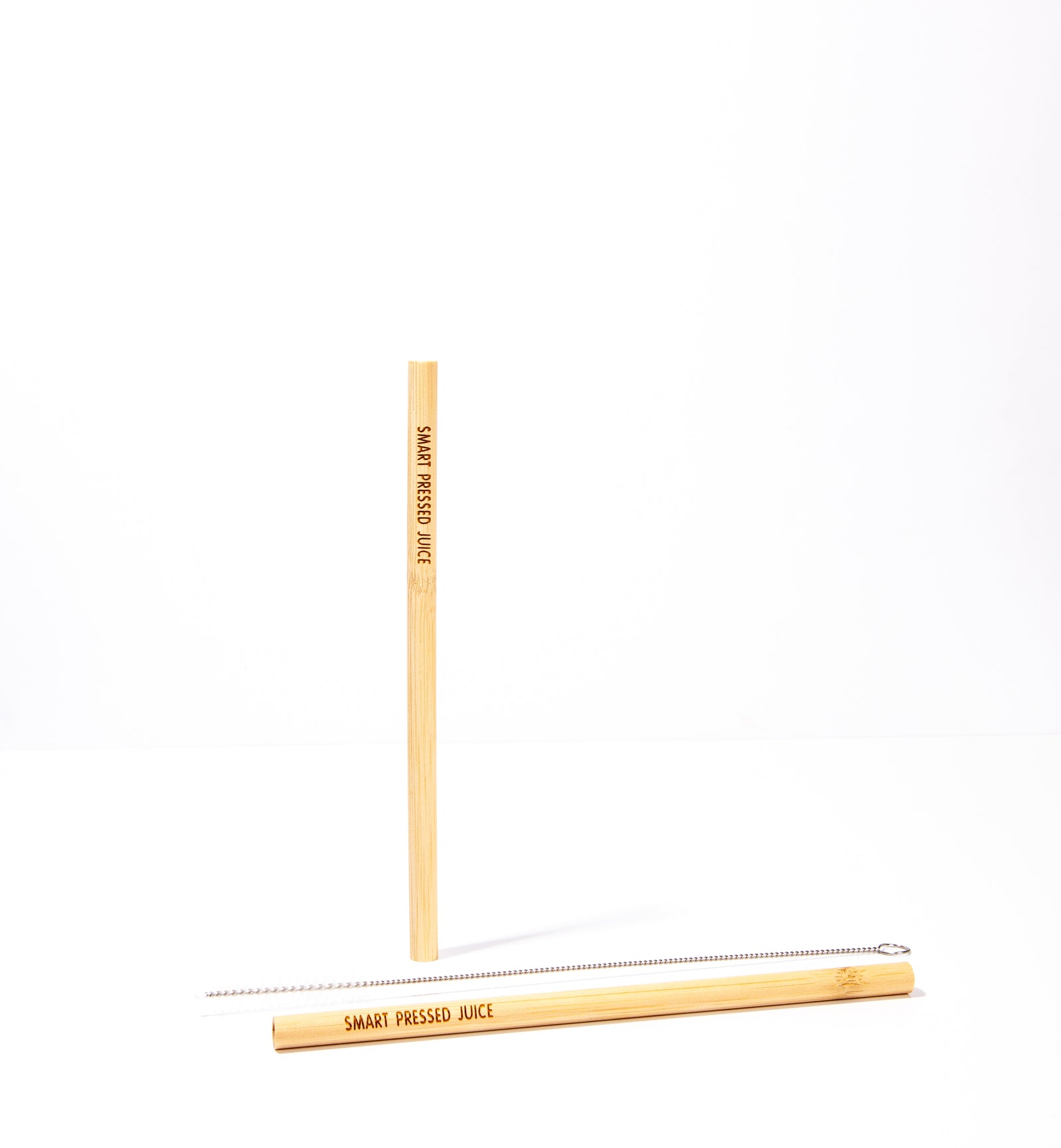 2 bamboo straws- one is in a standing position and the other one is in a laying position against a white background.